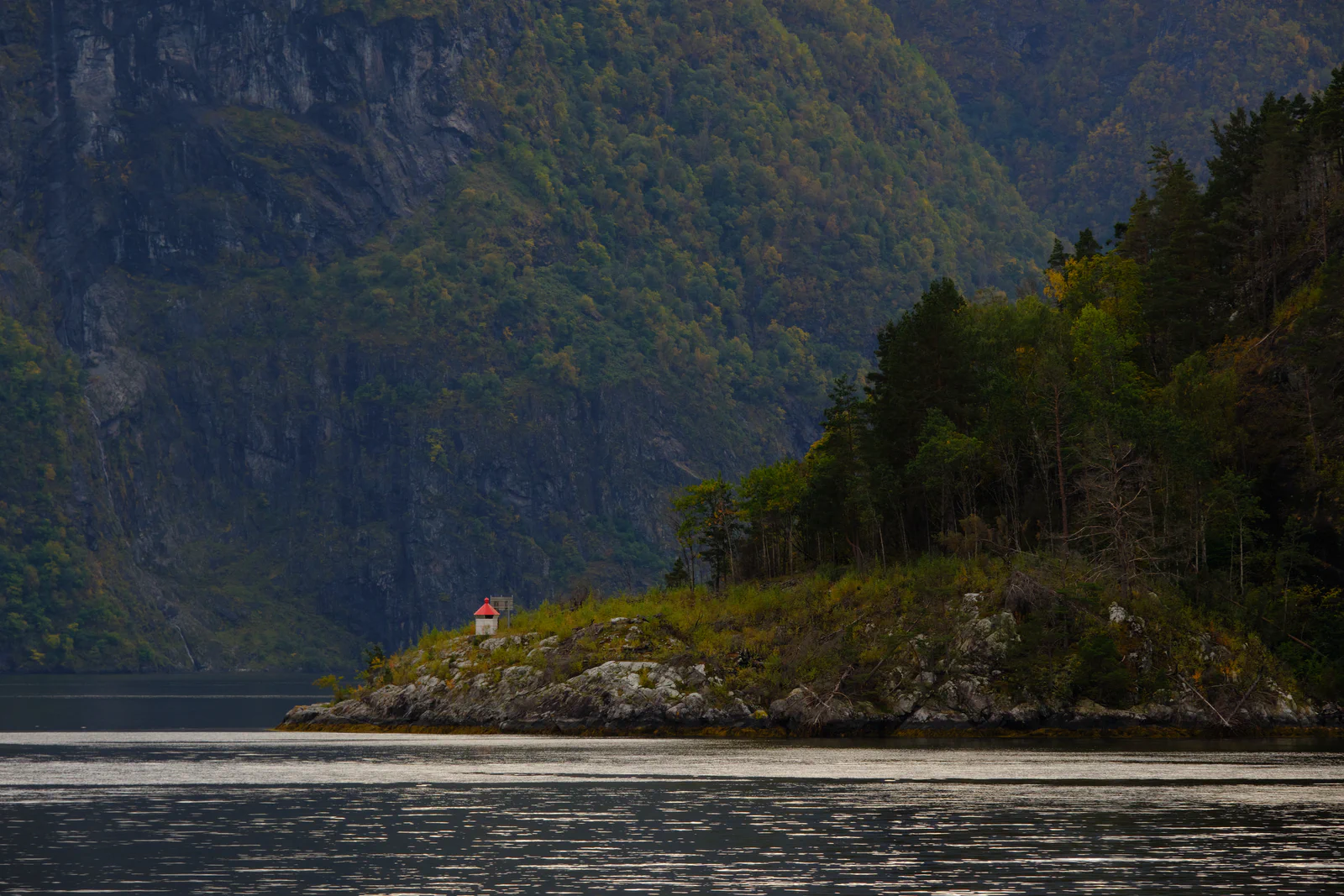 Small lighthouse on a headland in a fjord