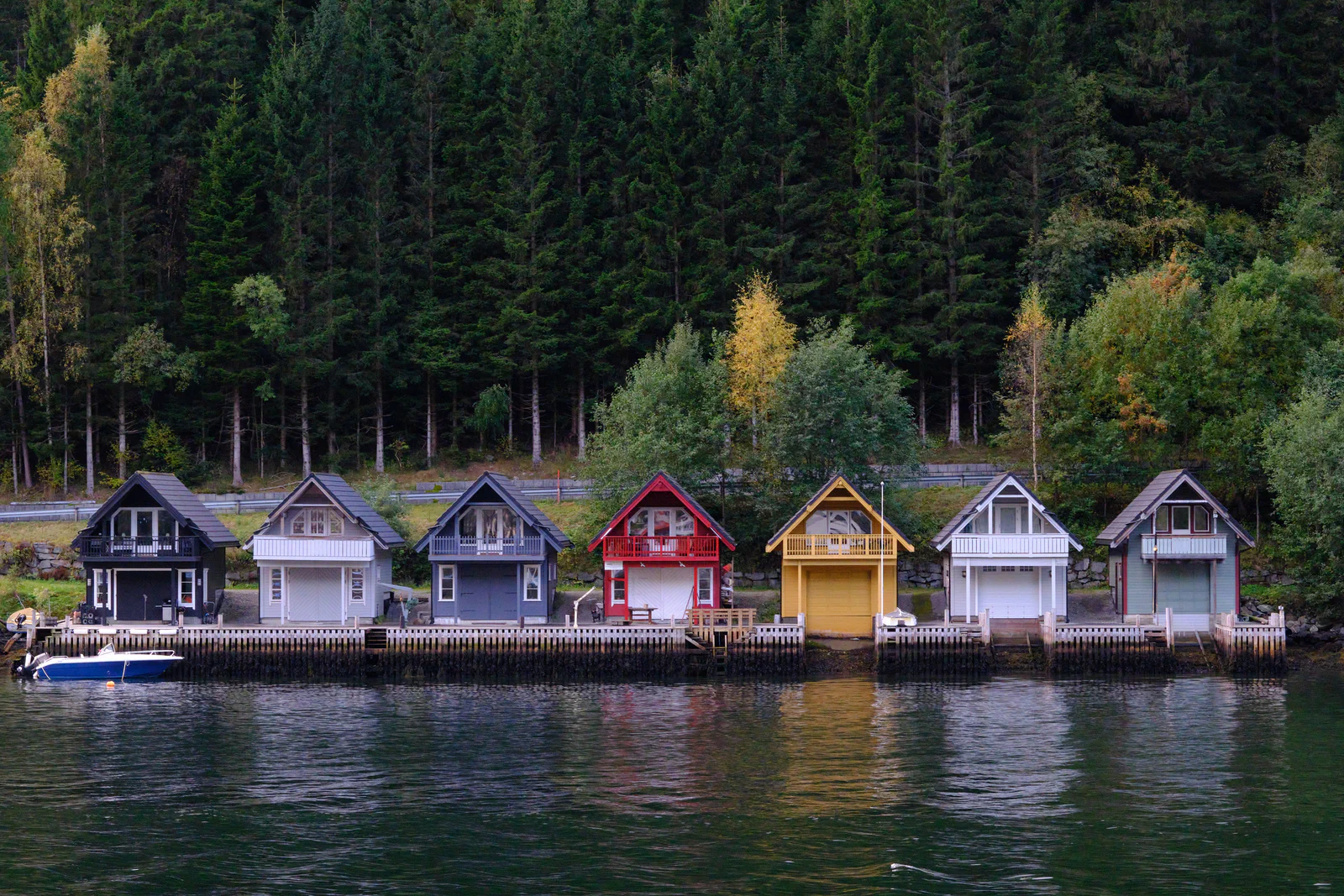 Colorful boathouses by the water