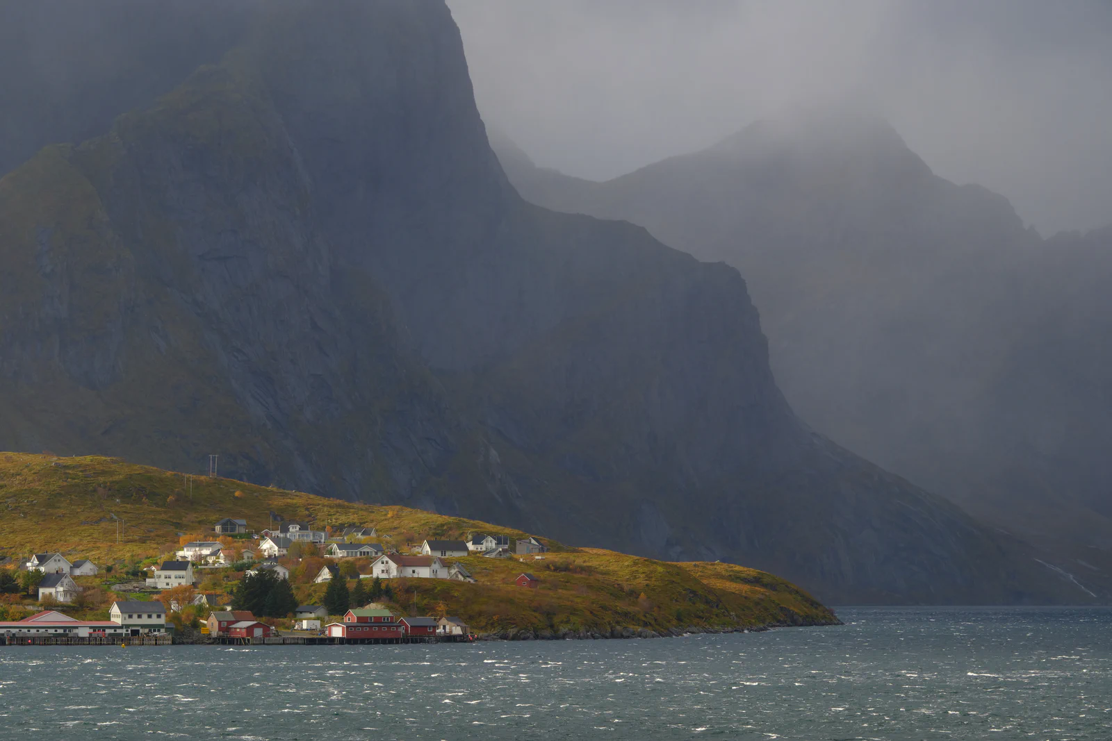 Village below the mountains in the rain